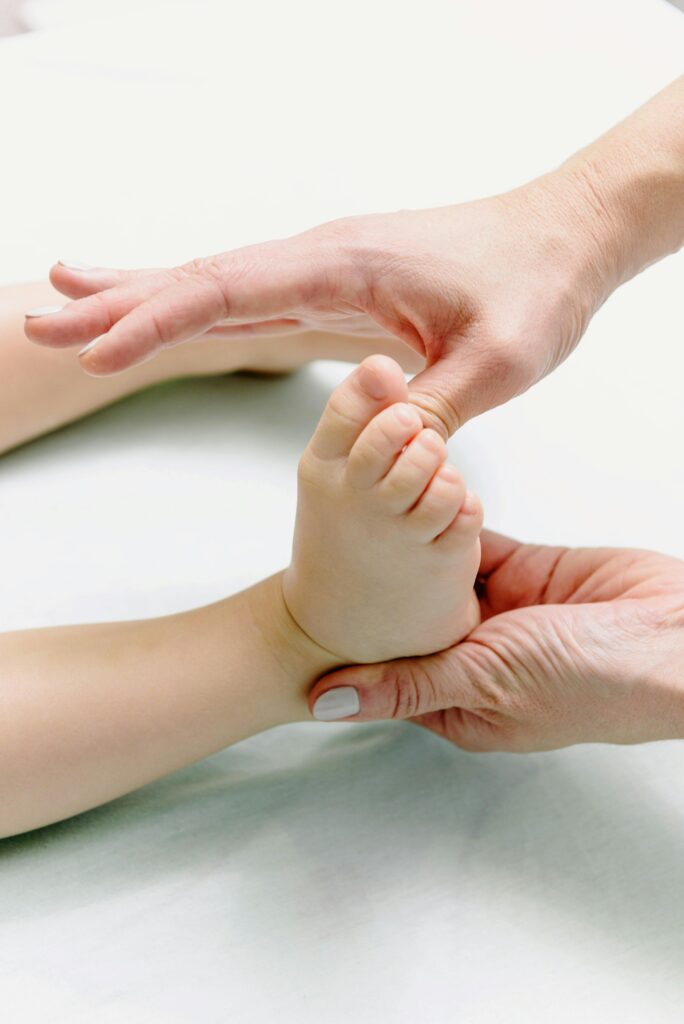 Tender close-up capturing hands massaging a baby's foot, symbolizing relaxation and care.